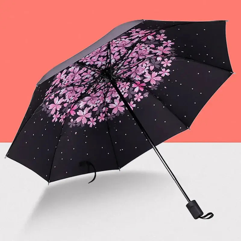 Black umbrella with pink cherry blossom design.