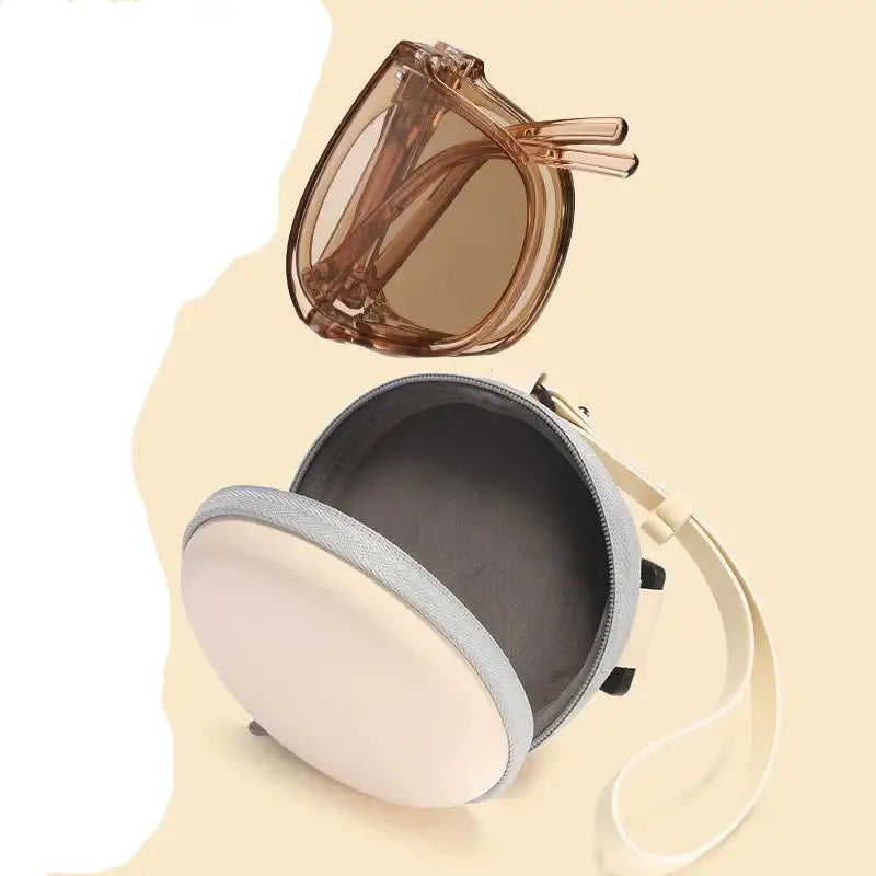 Foldable brown sunglasses and a round case.