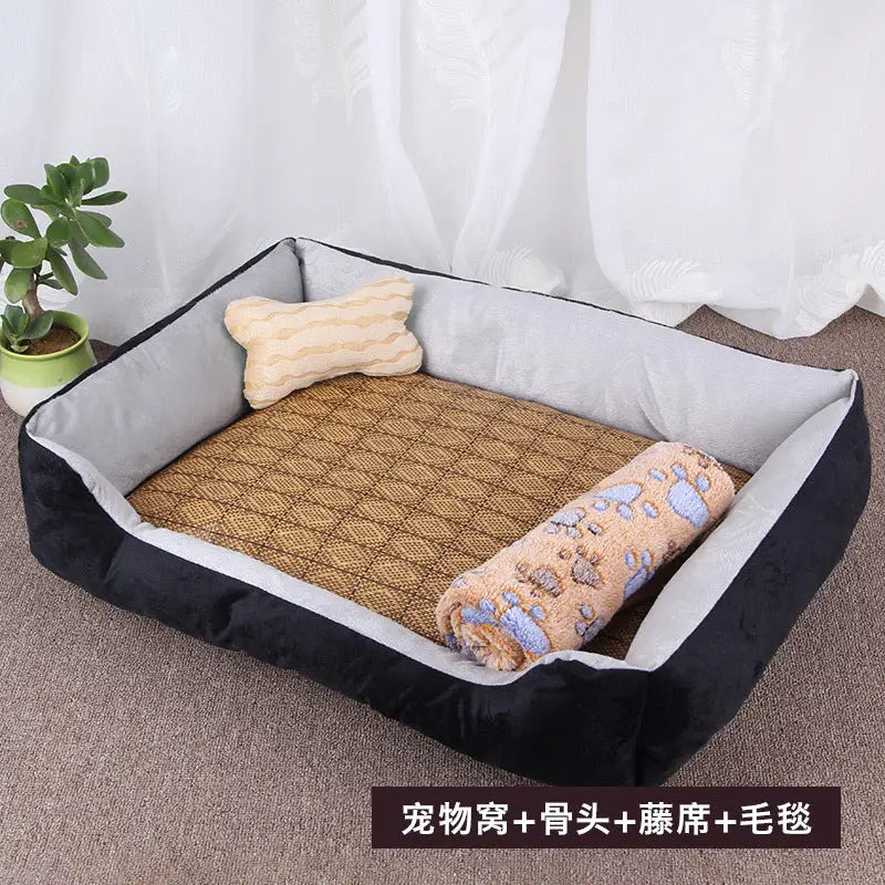 Black and gray pet bed with bone-shaped pillow, woven mat, and paw-print blanket.