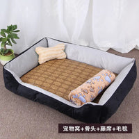 Black and gray pet bed with bone-shaped pillow, woven mat, and paw-print blanket.