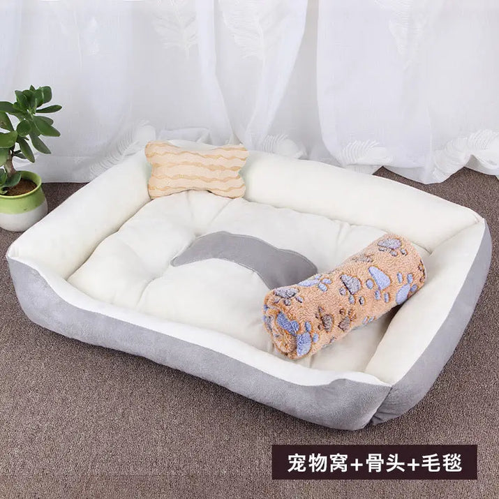 Gray and white pet bed with bone and paw-print pillows.