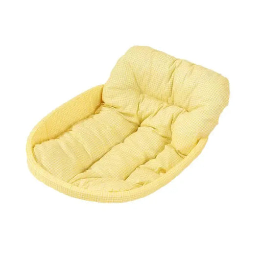 Yellow padded pet bed.