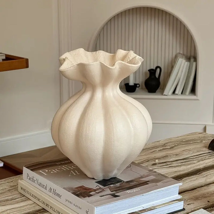 Cream-colored, ruffled-top vase.