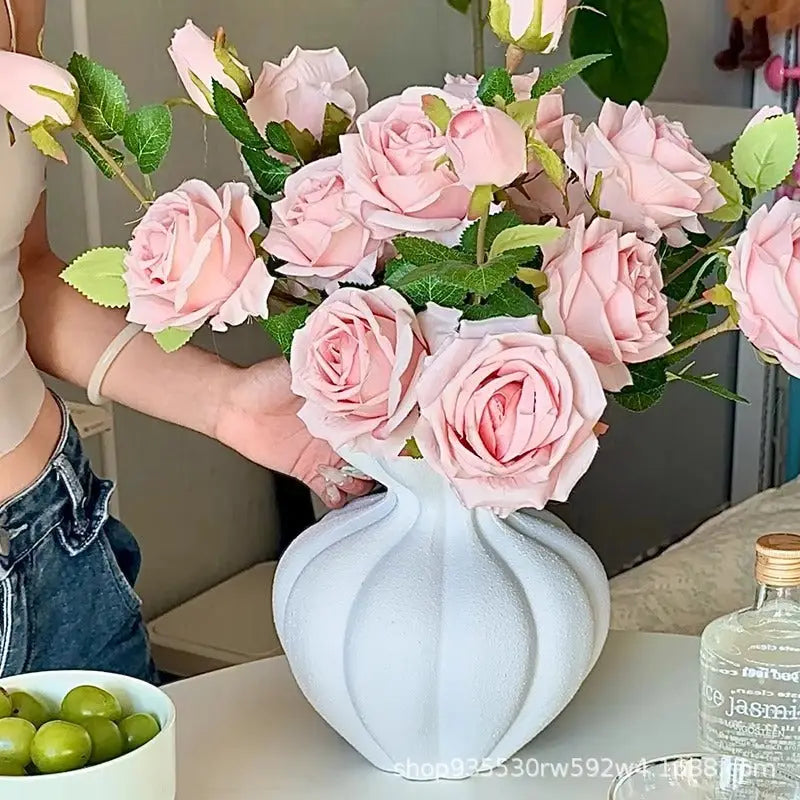 Pink roses in a white vase.