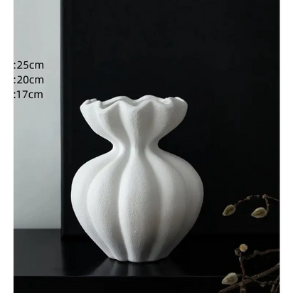 White ceramic vase with ruffled top.