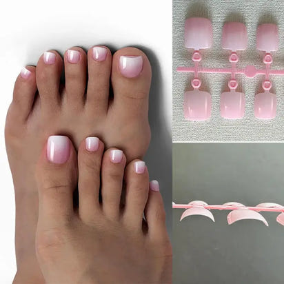 Pedicured feet with pink and white ombre nails.