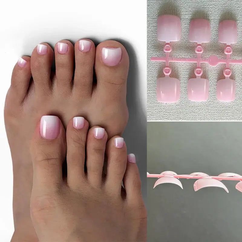 Pedicured feet with pink and white ombre nails.