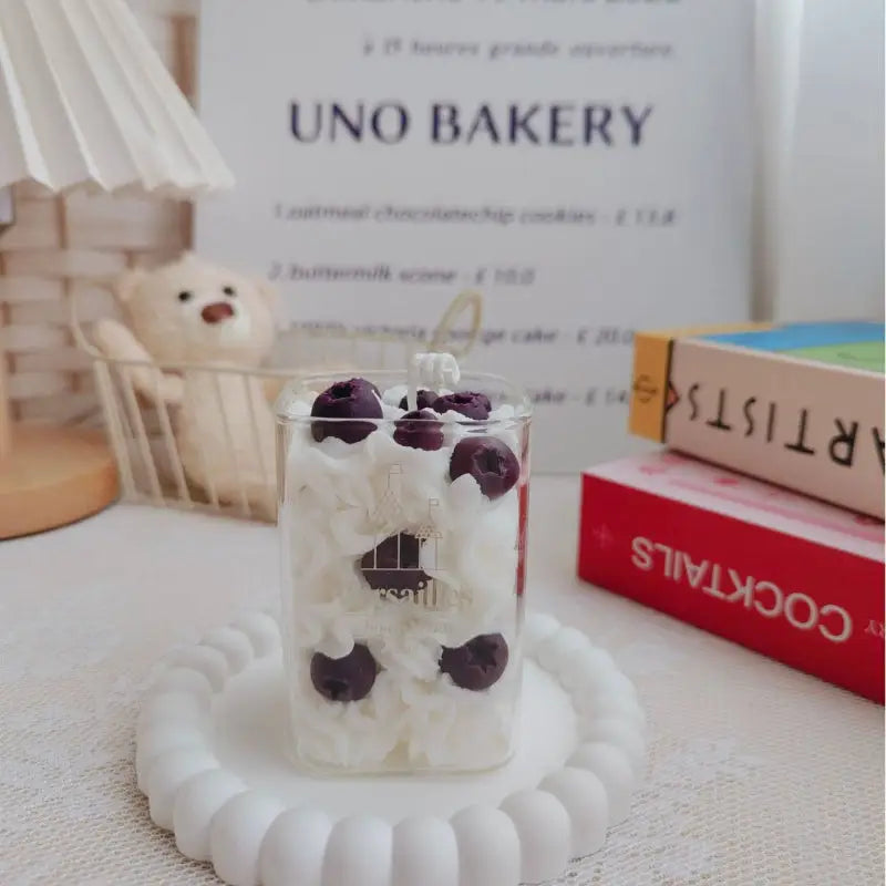 Cherry-topped dessert in a glass.