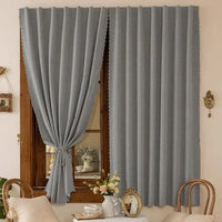 Gray scalloped curtains.