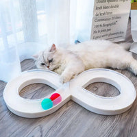 White infinity-shaped cat toy with colorful balls.