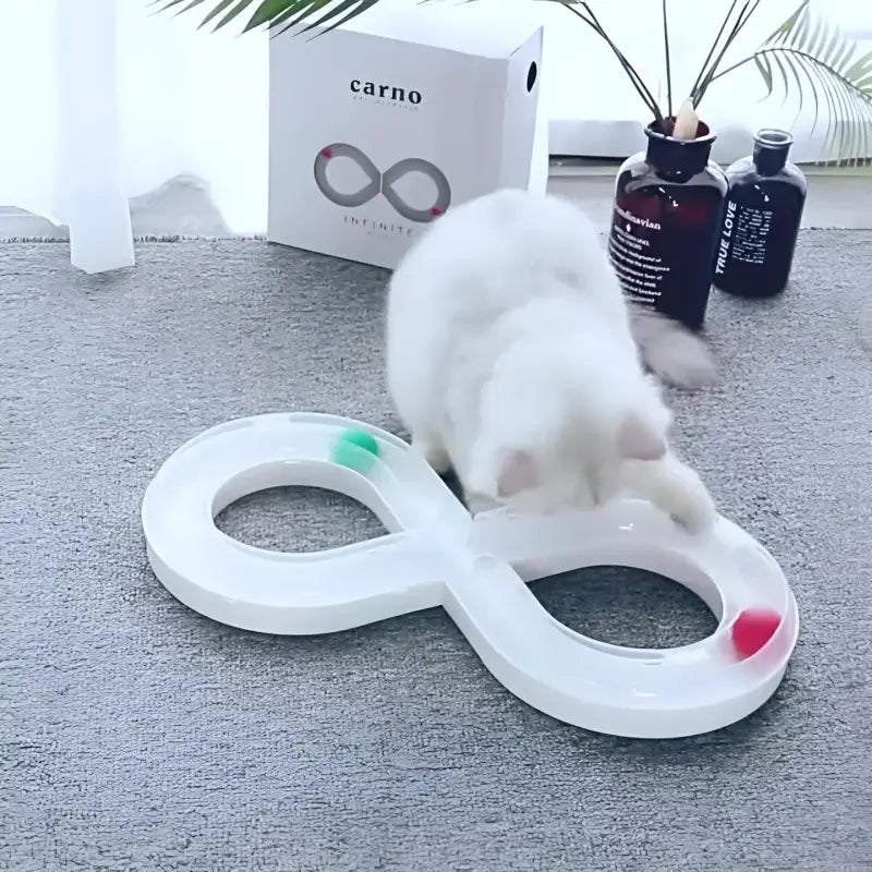 White infinity-shaped cat toy with colorful balls.