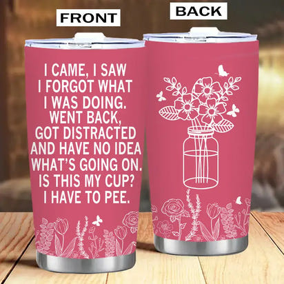 Pink tumbler with humorous text and floral design.