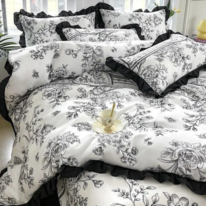 Floral patterned bedding set with black ruffles.