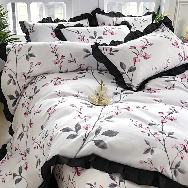 Floral patterned bedding set with black ruffled trim.