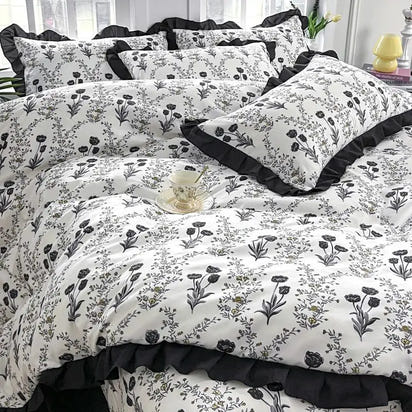 Floral patterned bedding with ruffled trim.
