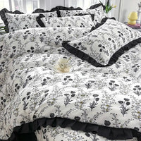 Floral patterned bedding with ruffled trim.