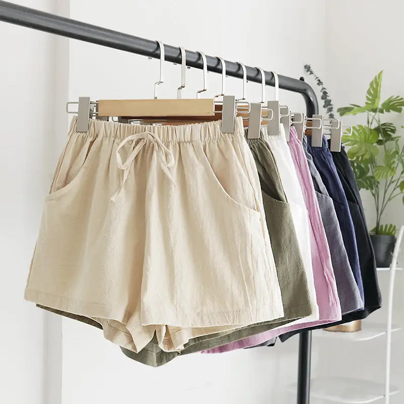 Colorful drawstring shorts on hangers.