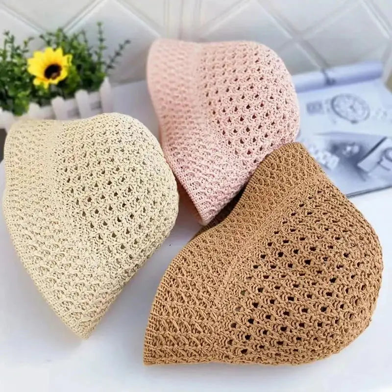 Three crocheted kufi caps.