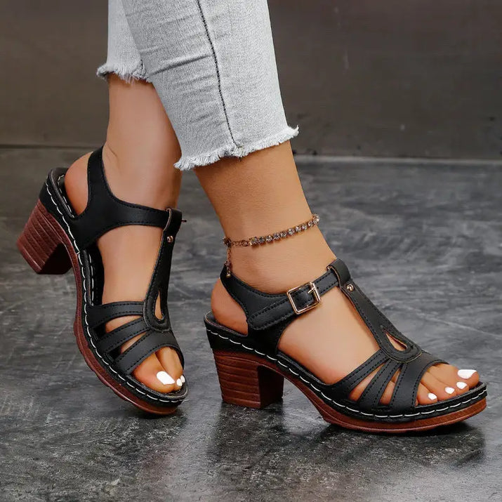 Black leather T-strap sandals.