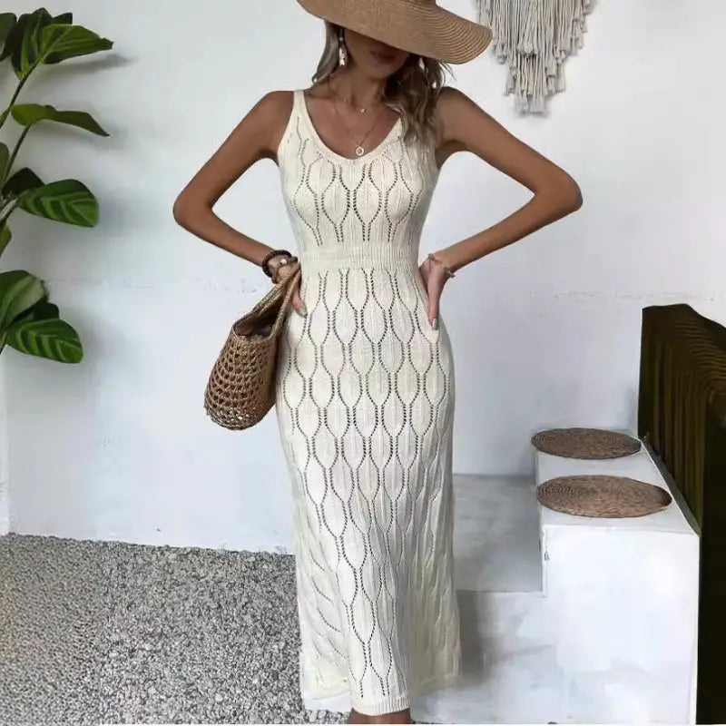 Knit midi dress with a straw hat and bag.