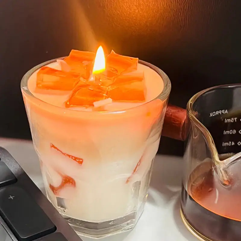 Burning candle with orange accents.