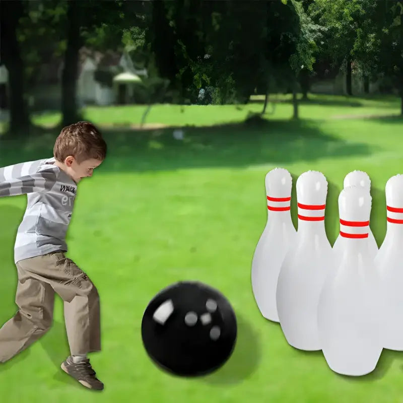 Child bowling outdoors.