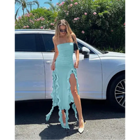 Light blue strapless dress with ruffled slits.