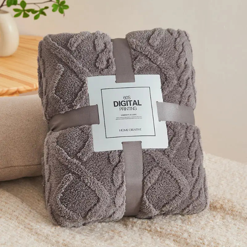 Folded gray plush blanket.
