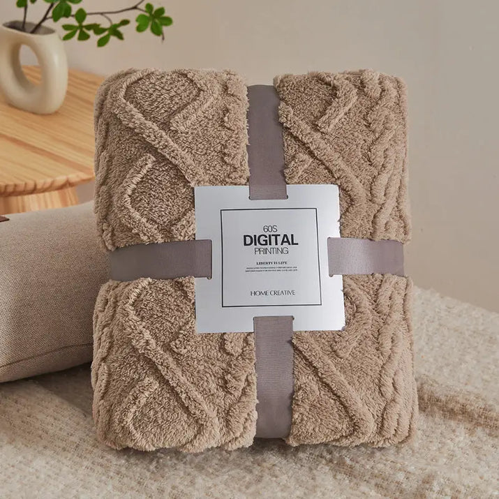 Beige cable-knit throw blanket.