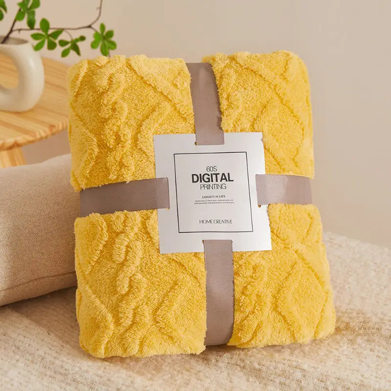 Folded yellow plush blanket.