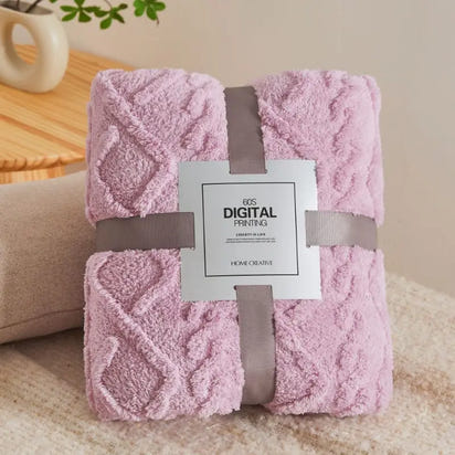Folded pink textured blanket.