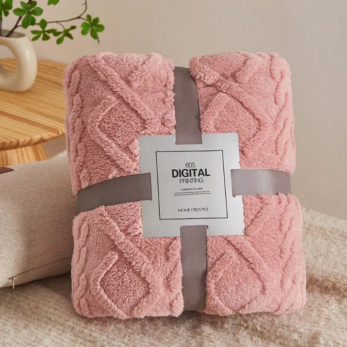 Pink, cable-knit, plush blanket.
