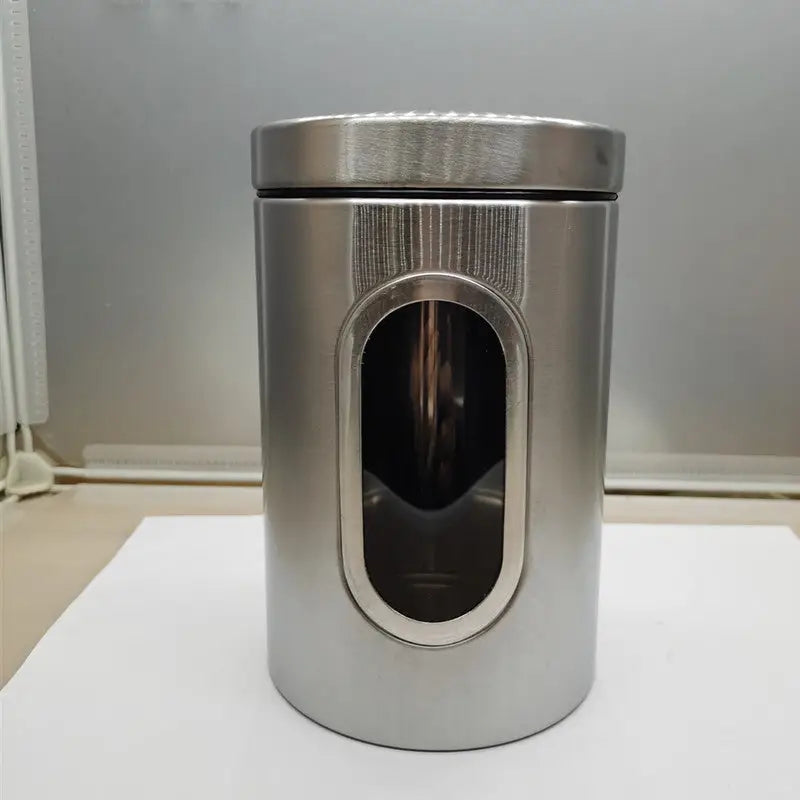 Cylindrical metal canister with viewing window.