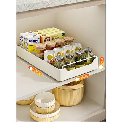Pull-out storage tray with various food items on kitchen pull-out shelves in a modern kitchen