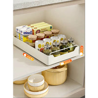 Pull-out storage tray with various food items on kitchen pull-out shelves in a modern kitchen