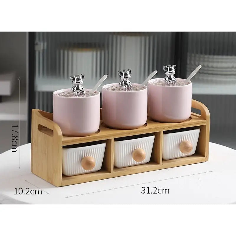 Pink ceramic spice jar set with bear-shaped lids.