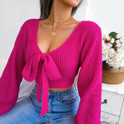 Hot pink tie-front knit sweater.