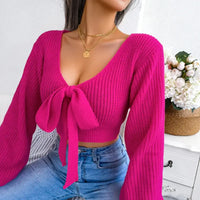 Hot pink tie-front knit sweater.
