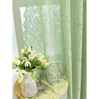 Green patterned sheer curtain.