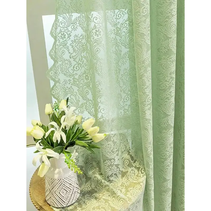 Green patterned sheer curtain.