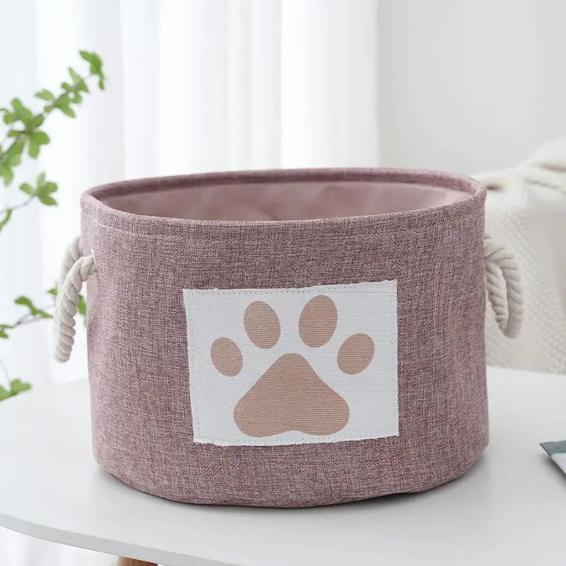 Mauve fabric storage bin with paw print.