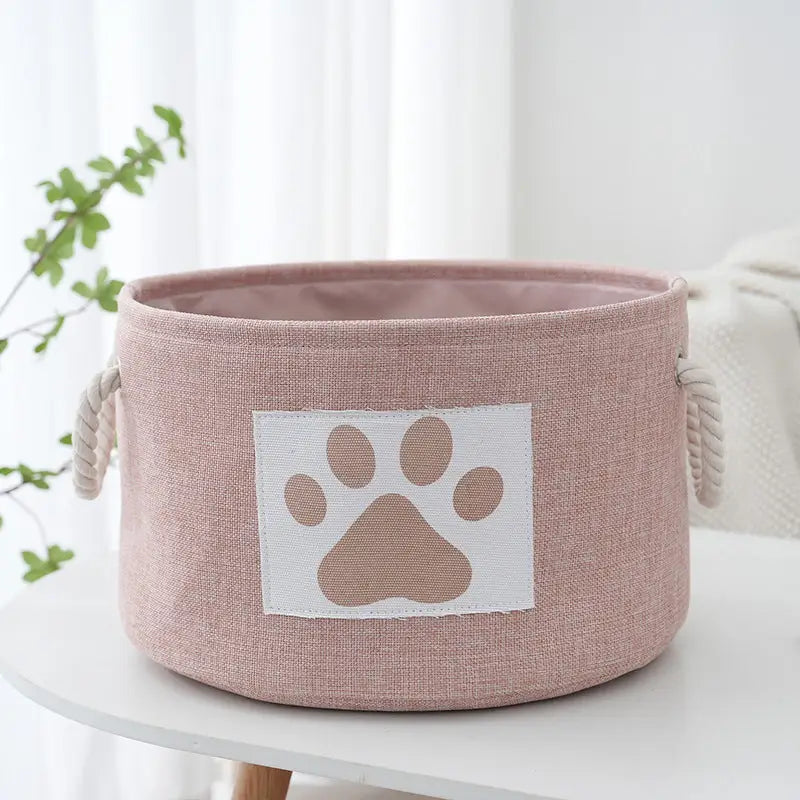 Pink fabric storage bin with paw print.