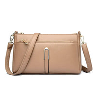 Beige leather crossbody bag.