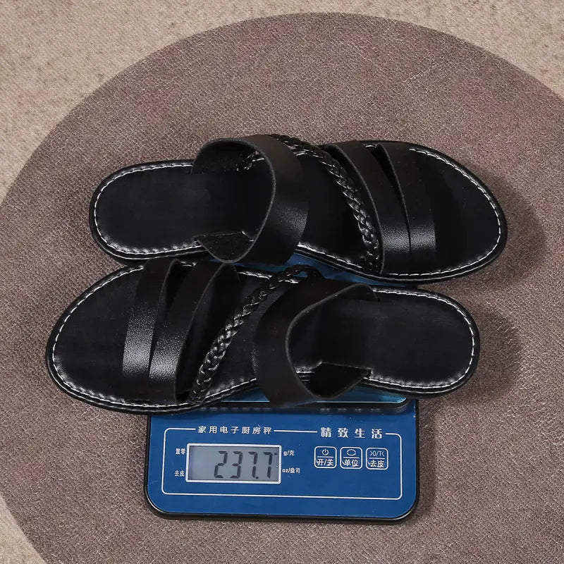 Black leather sandals on a scale.