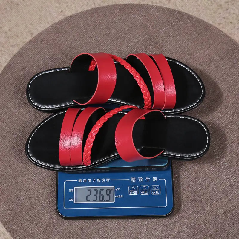 Red leather sandals on a scale.