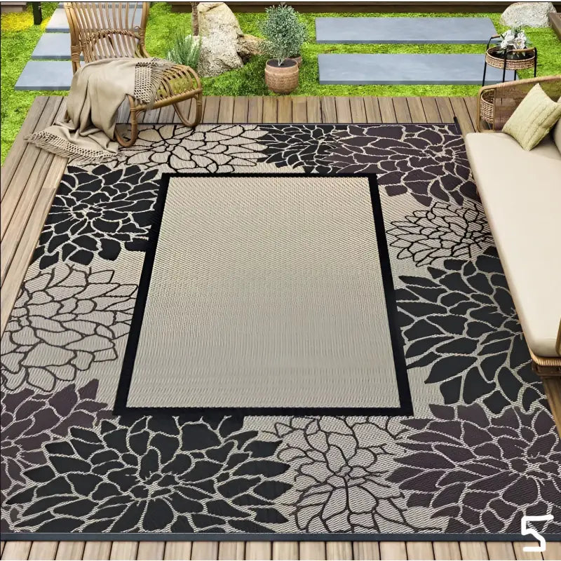 Floral-bordered outdoor rug.