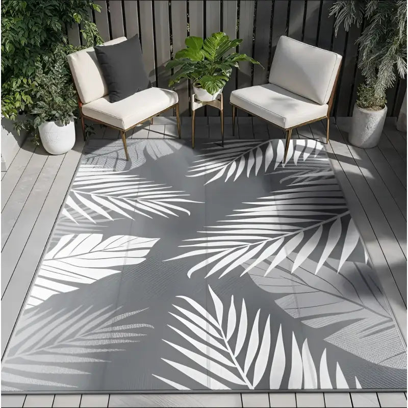 Gray rug with white leaf pattern.