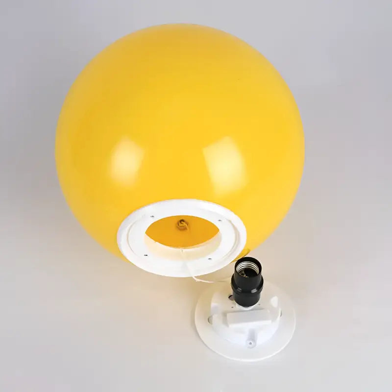 Yellow spherical lamp with white base.