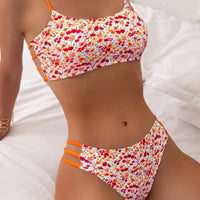 Floral print bikini with orange straps.