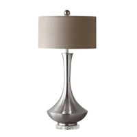 Silver table lamp with beige shade.